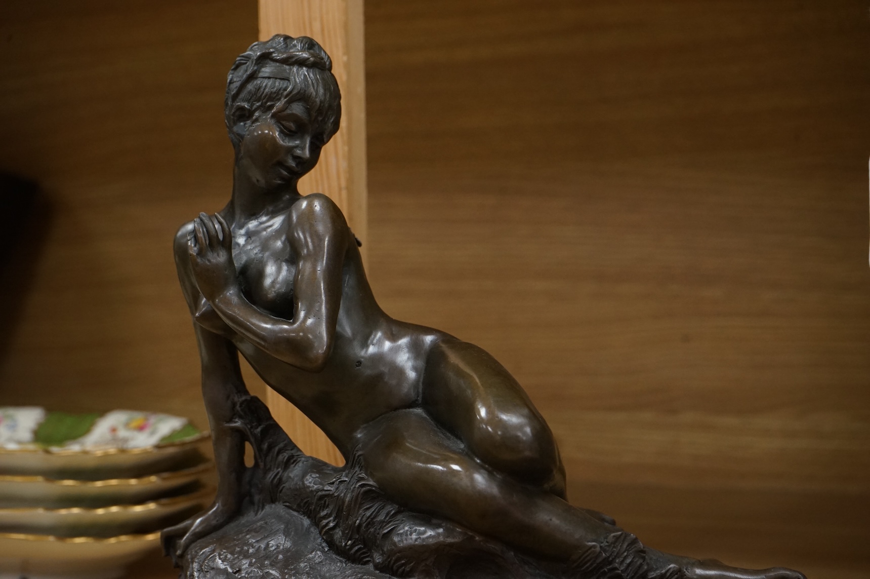 After Mme Leon Bertaux, bronze of a female reclining nude with butterfly, 28cm wide x 27cm high.